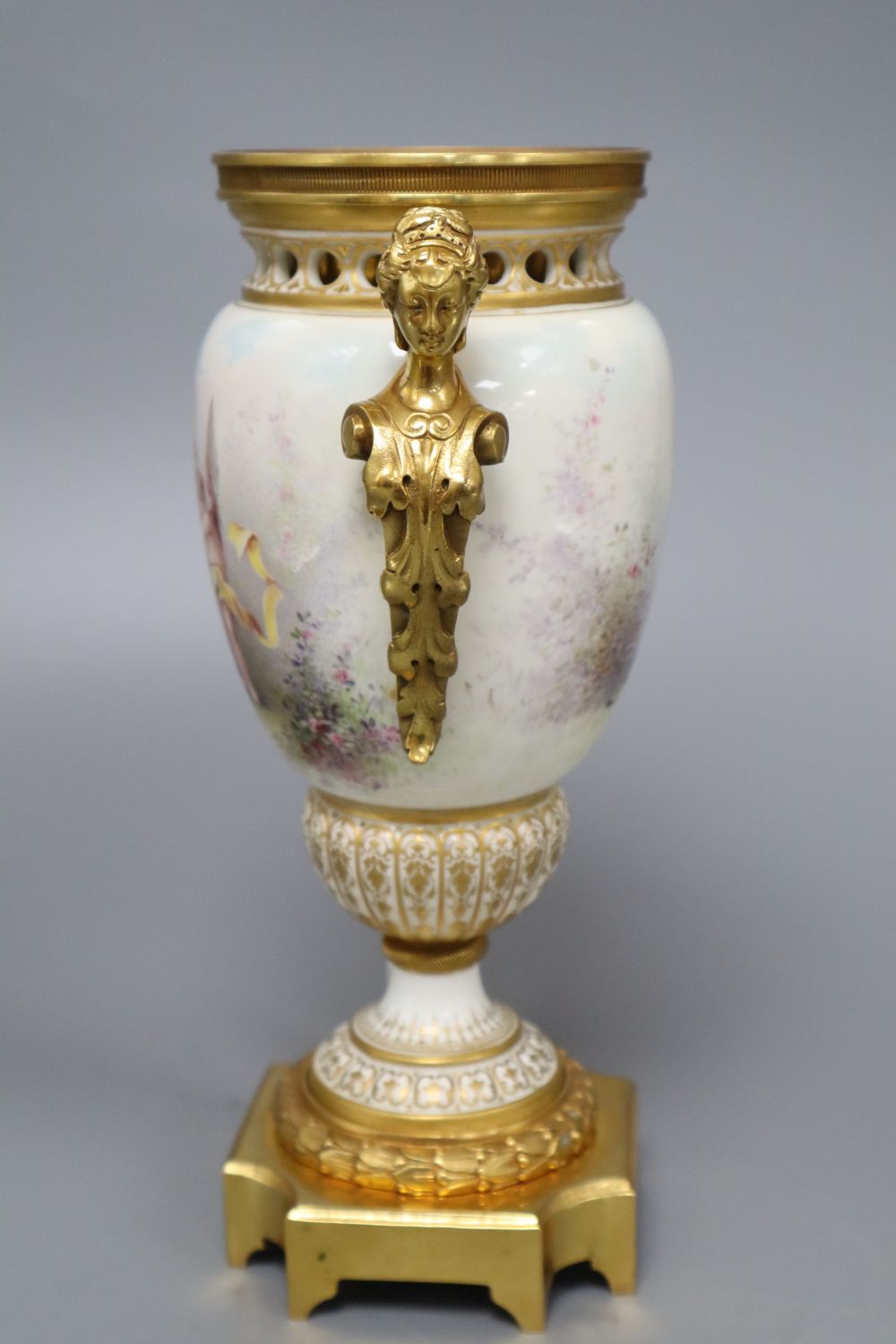 A French painted porcelain and gilt metal two-handled vase, signed I Marchand, height 23.5cm (lacking cover),